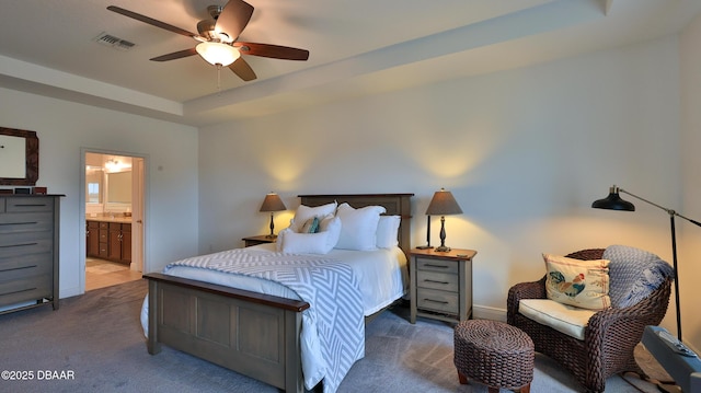 bedroom with visible vents, ensuite bathroom, a tray ceiling, carpet flooring, and ceiling fan