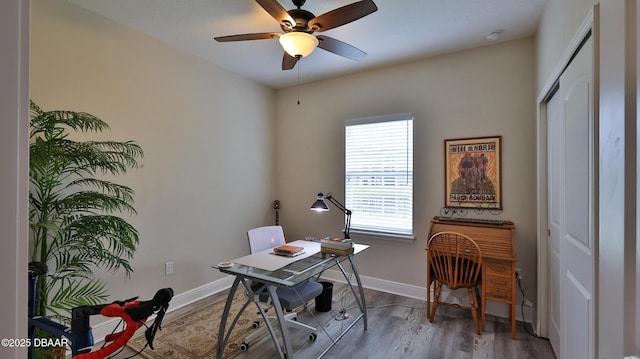 office with a ceiling fan, baseboards, and wood finished floors