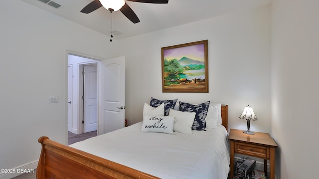 carpeted bedroom with visible vents, baseboards, and ceiling fan