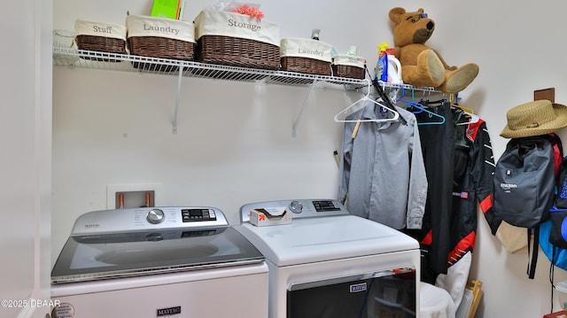 clothes washing area with independent washer and dryer and laundry area