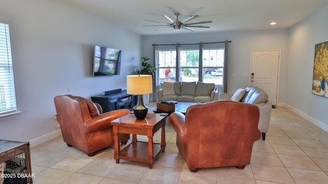 living room with baseboards, a healthy amount of sunlight, ceiling fan, and light tile patterned flooring