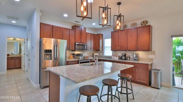 kitchen with visible vents, appliances with stainless steel finishes, decorative backsplash, and a sink