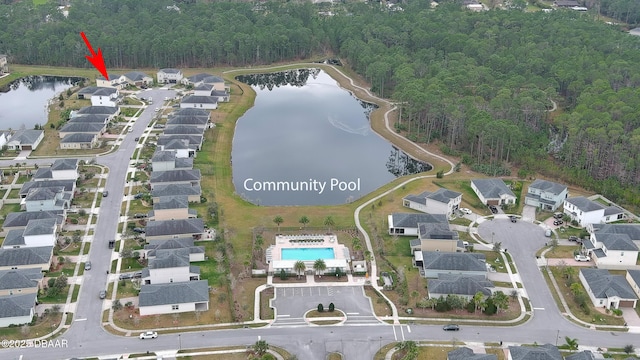 birds eye view of property with a view of trees, a water view, and a residential view