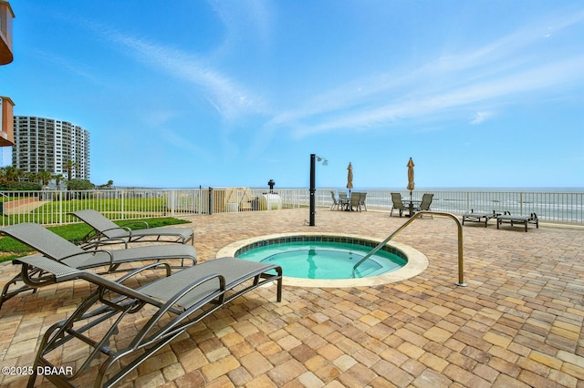 2515 S Atlantic Ave Unit 502, Daytona Beach, FL 32118 - view of pool with a community hot tub, a patio, and a water view
