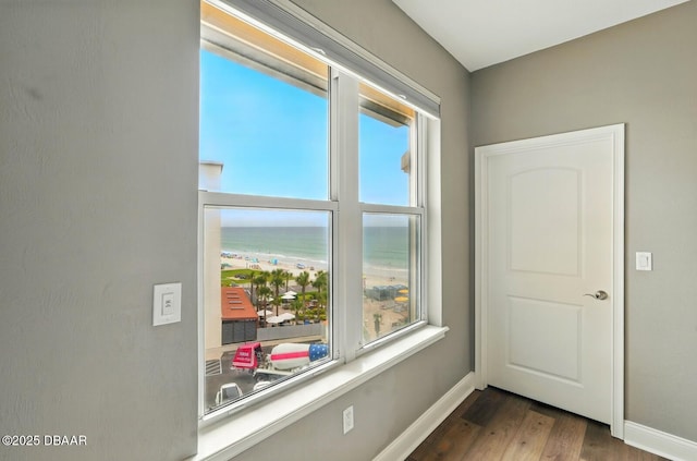 2515 S Atlantic Ave Unit 502, Daytona Beach, FL 32118 - spare room with wood finished floors, a water view, and baseboards
