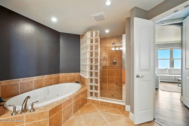 2515 S Atlantic Ave Unit 502, Daytona Beach, FL 32118 - bathroom featuring a stall shower, a jetted tub, recessed lighting, and tile patterned floors