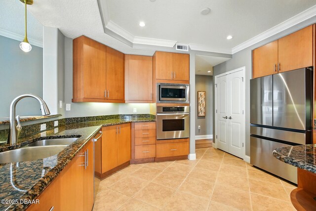 2515 S Atlantic Ave Unit 502, Daytona Beach, FL 32118 - kitchen with appliances with stainless steel finishes, a sink, crown molding, dark stone counters, and light tile patterned flooring