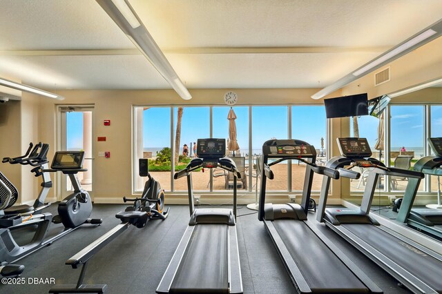 2515 S Atlantic Ave Unit 502, Daytona Beach, FL 32118 - gym featuring healthy amount of natural light, beam ceiling, and baseboards