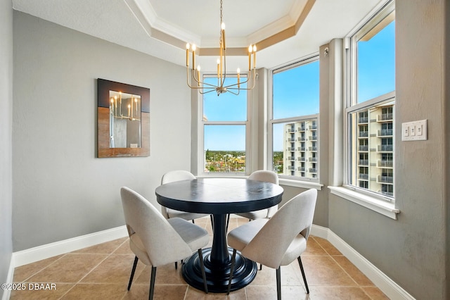 2515 S Atlantic Ave Unit 502, Daytona Beach, FL 32118 - dining area with a chandelier, a tray ceiling, crown molding, tile patterned floors, and baseboards