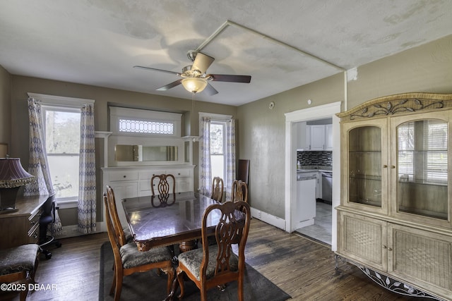 dining space featuring ceiling fan, dark wood-style flooring, and a wealth of natural light