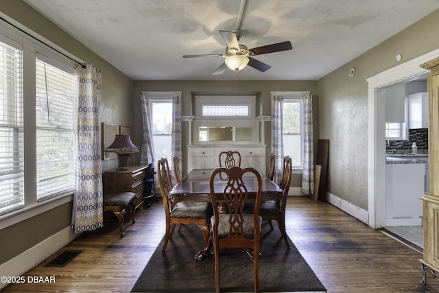 dining area featuring a ceiling fan, visible vents, a healthy amount of sunlight, and wood finished floors