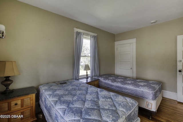 bedroom with baseboards and wood finished floors