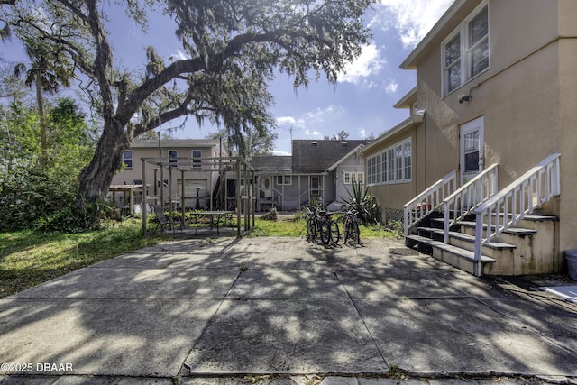surrounding community with a patio and outdoor dining space