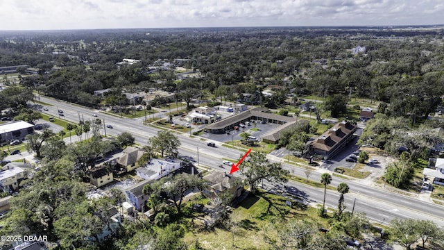 drone / aerial view with a wooded view