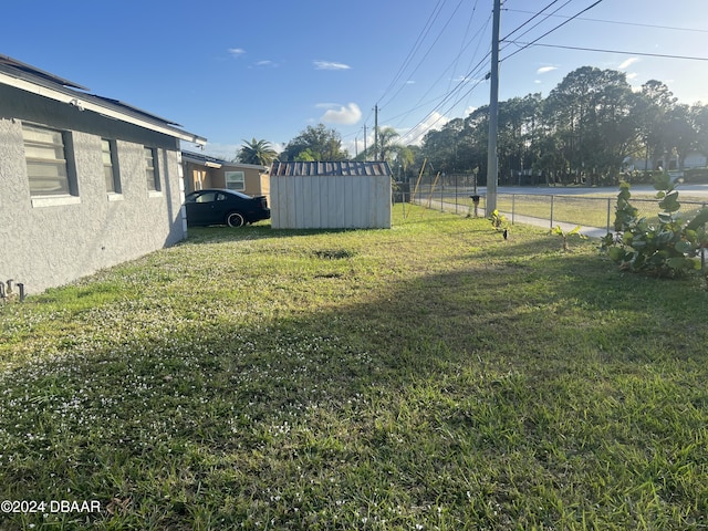 view of yard with an outdoor structure and fence