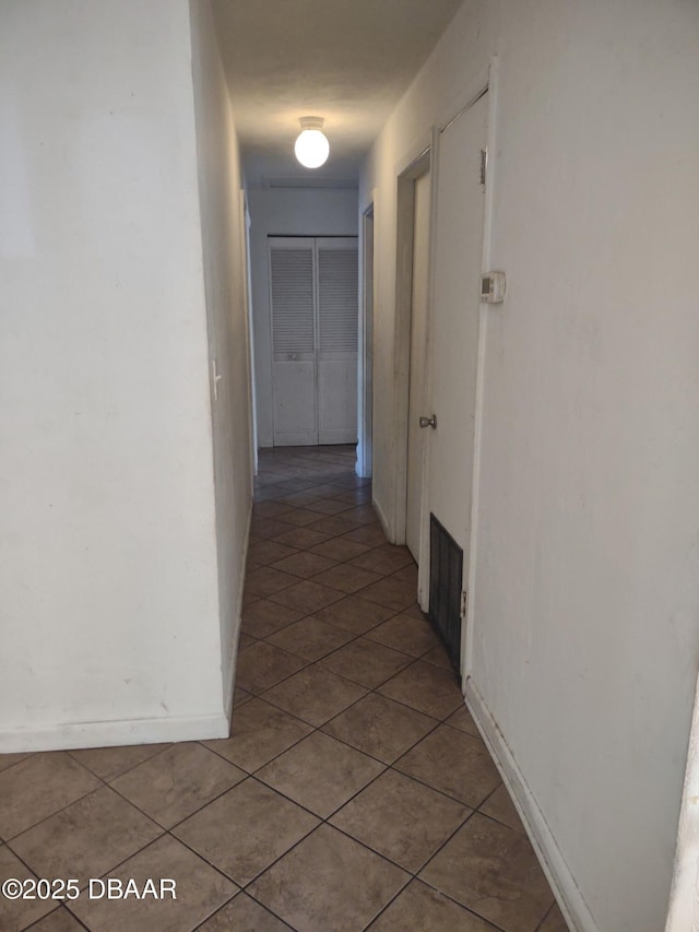 hallway featuring tile patterned flooring