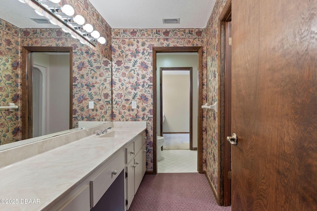 7 Appaloosa Trl, Ormond Beach, FL 32174 - bathroom featuring wallpapered walls, toilet, vanity, and a textured ceiling