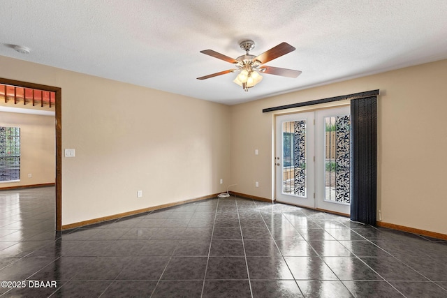 7 Appaloosa Trl, Ormond Beach, FL 32174 - unfurnished room featuring baseboards, dark tile patterned floors, ceiling fan, and a textured ceiling
