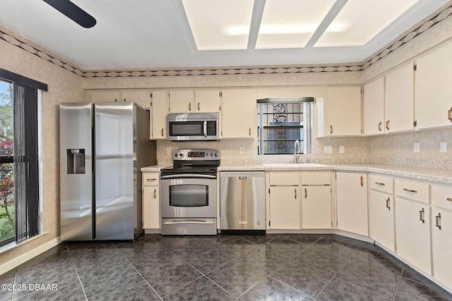 7 Appaloosa Trl, Ormond Beach, FL 32174 - kitchen with stainless steel appliances, a sink, light countertops, and backsplash