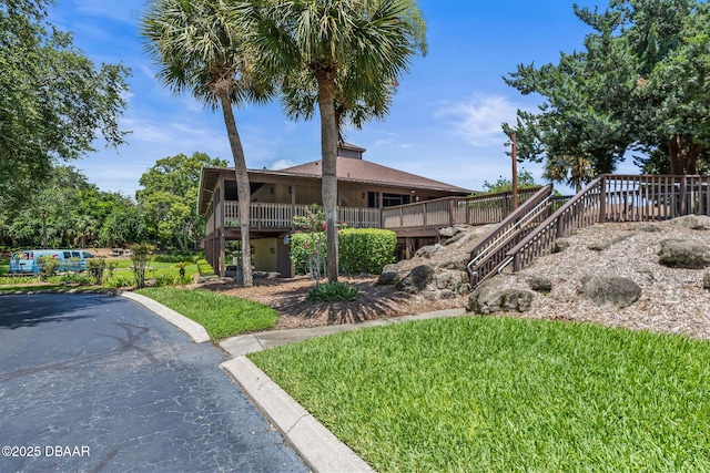 7 Appaloosa Trl, Ormond Beach, FL 32174 - back of house featuring stairs and a yard