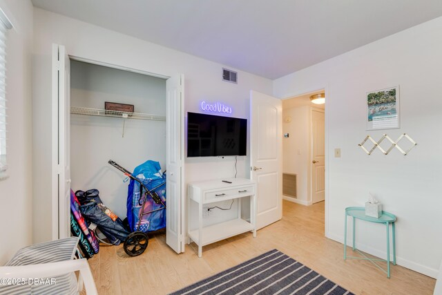 bedroom with hardwood / wood-style flooring and a closet