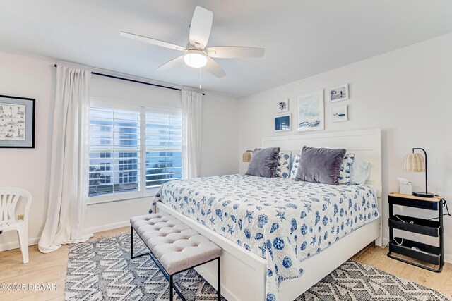 bedroom with ceiling fan and light hardwood / wood-style flooring