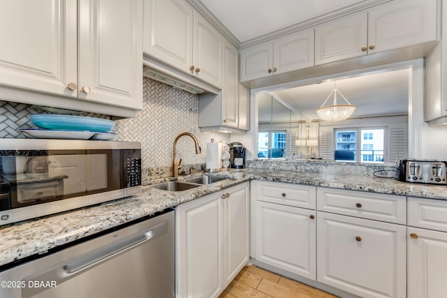 kitchen featuring white cabinetry and sink