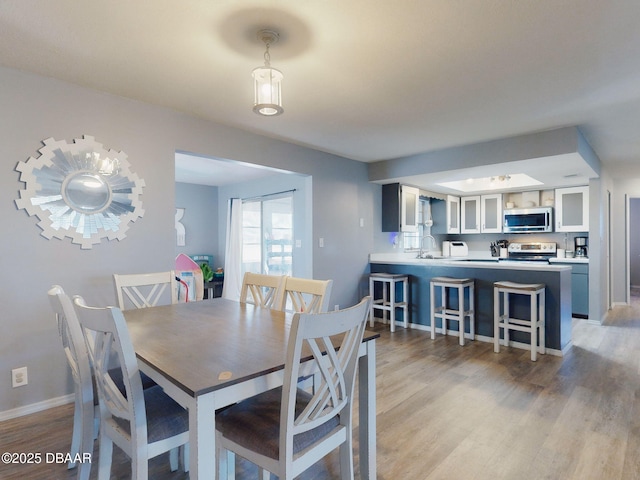 dining room featuring light hardwood / wood-style flooring and sink