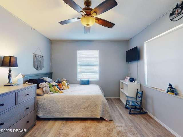 bedroom with light wood-type flooring and ceiling fan