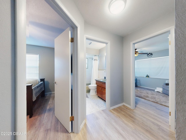 hallway with light hardwood / wood-style floors