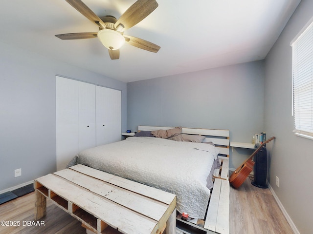 bedroom featuring a closet, ceiling fan, and wood-type flooring