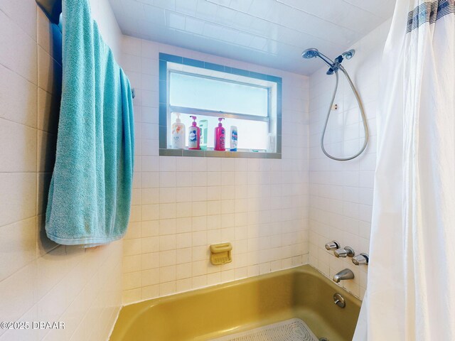 bathroom with shower / bath combo with shower curtain