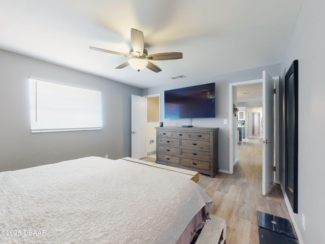 bedroom with ceiling fan and light hardwood / wood-style floors