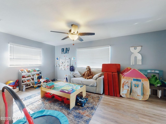 playroom featuring ceiling fan and light hardwood / wood-style flooring