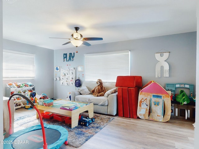 playroom featuring ceiling fan and light hardwood / wood-style flooring