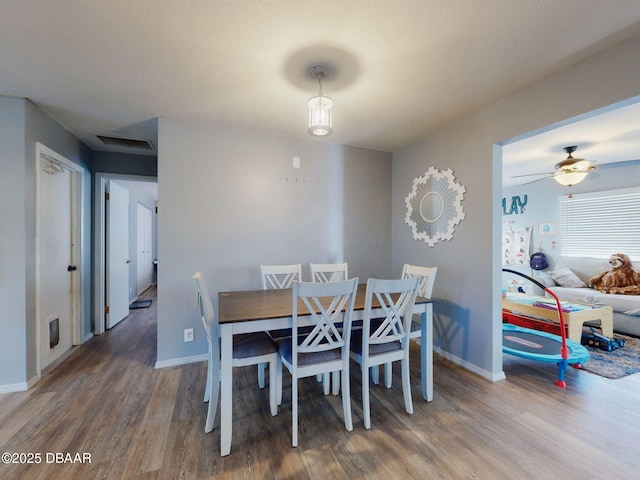 dining area with ceiling fan and hardwood / wood-style floors