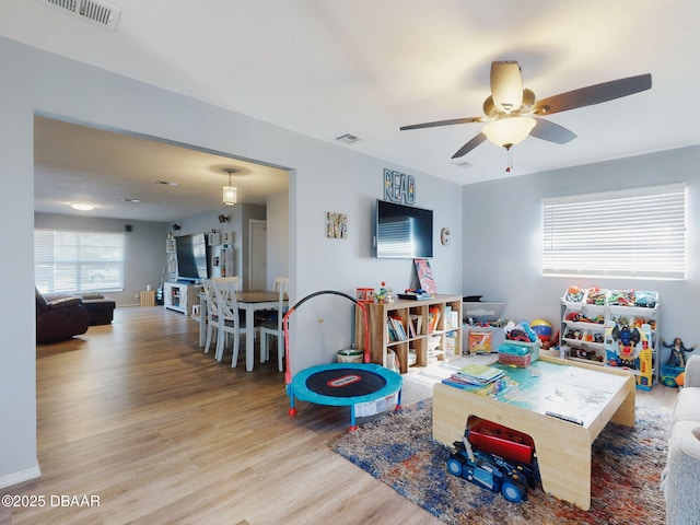 recreation room featuring ceiling fan and light hardwood / wood-style flooring