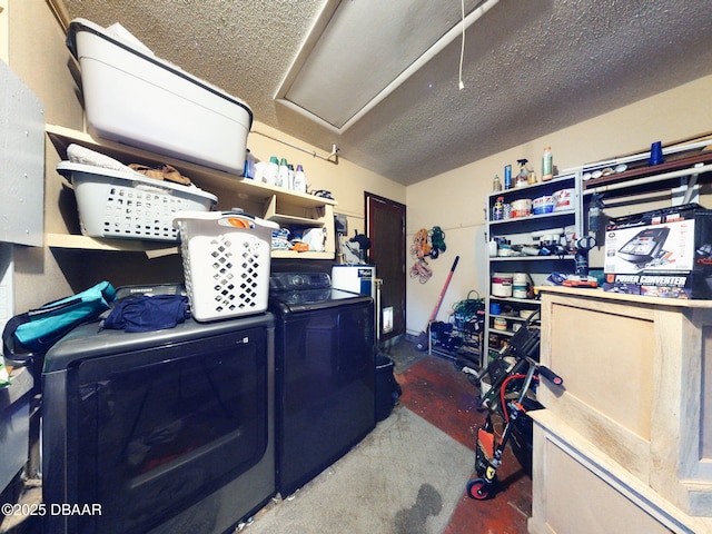 laundry room with a textured ceiling and washing machine and clothes dryer