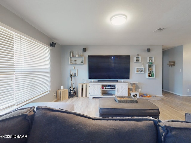 living room featuring hardwood / wood-style floors and radiator