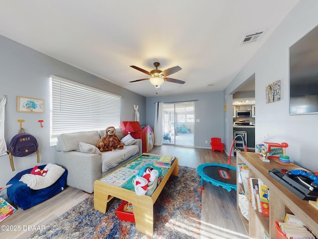 living room featuring hardwood / wood-style flooring and ceiling fan