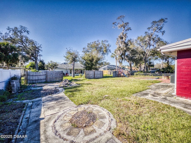 view of yard with a playground and a patio