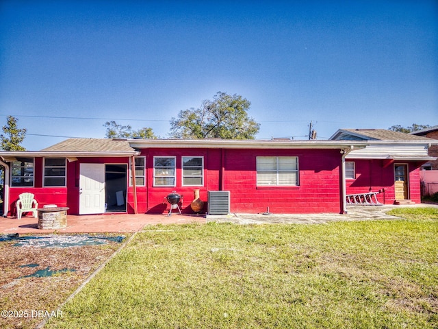 ranch-style home with a front yard and central AC unit