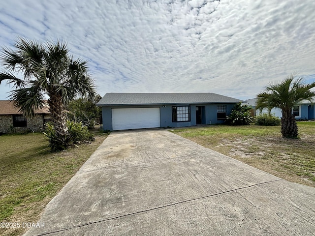 view of front facade with an attached garage, a front lawn, concrete driveway, and stucco siding