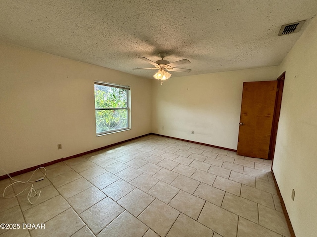 unfurnished room featuring light tile patterned floors, a textured ceiling, visible vents, baseboards, and a ceiling fan