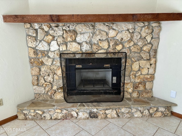 details featuring a fireplace with raised hearth and baseboards