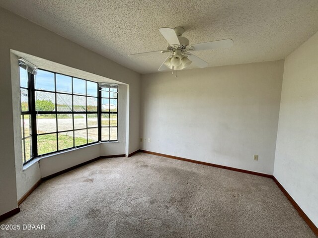156 Riverwalk Ct, Ormond Beach, FL 32176 - empty room featuring baseboards, a textured ceiling, carpet flooring, and a ceiling fan