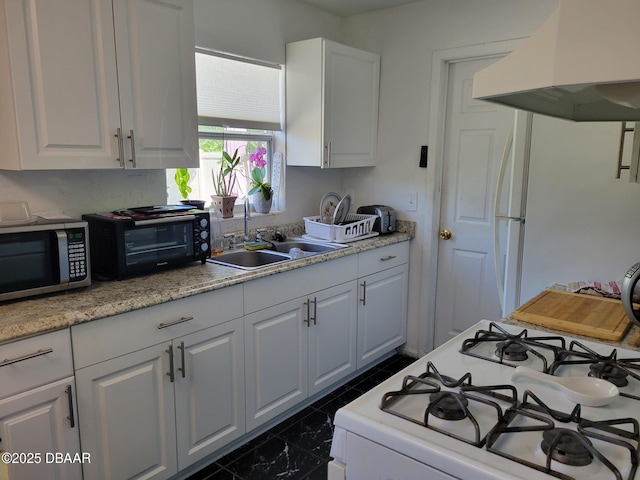1956 Linda Ave, Ormond Beach, FL 32174 - kitchen with premium range hood, stainless steel microwave, gas range oven, a sink, and white cabinetry