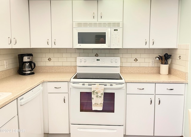 kitchen with white cabinets, tasteful backsplash, and white appliances