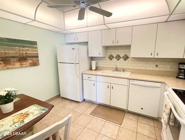 kitchen with white cabinets, sink, tasteful backsplash, light tile patterned flooring, and white appliances