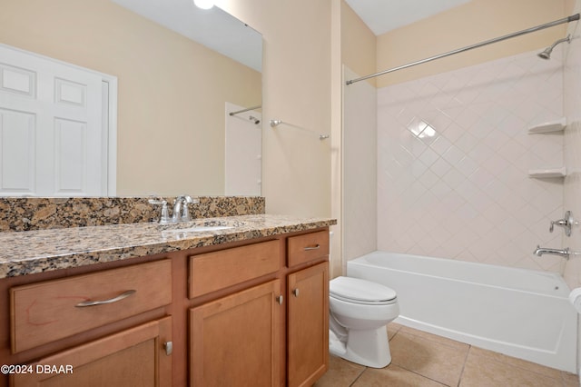 full bathroom featuring vanity, tile patterned flooring, toilet, and tiled shower / bath combo